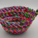 This view is looking at the fabric bowl from the side, showing all the colors of fabric scraps and another view of the knot. This view is looking at the fabric bowl from the side, showing all the colors of fabric scraps and another view of the knot.